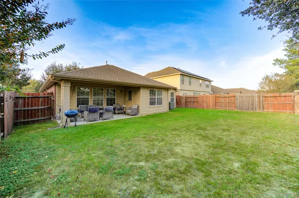 a view of a house with a yard porch and sitting area