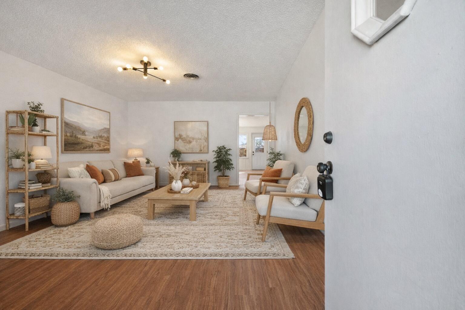 a living room with furniture and wooden floor