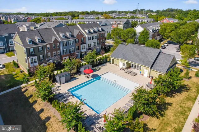 an aerial view of residential houses with outdoor space and parking