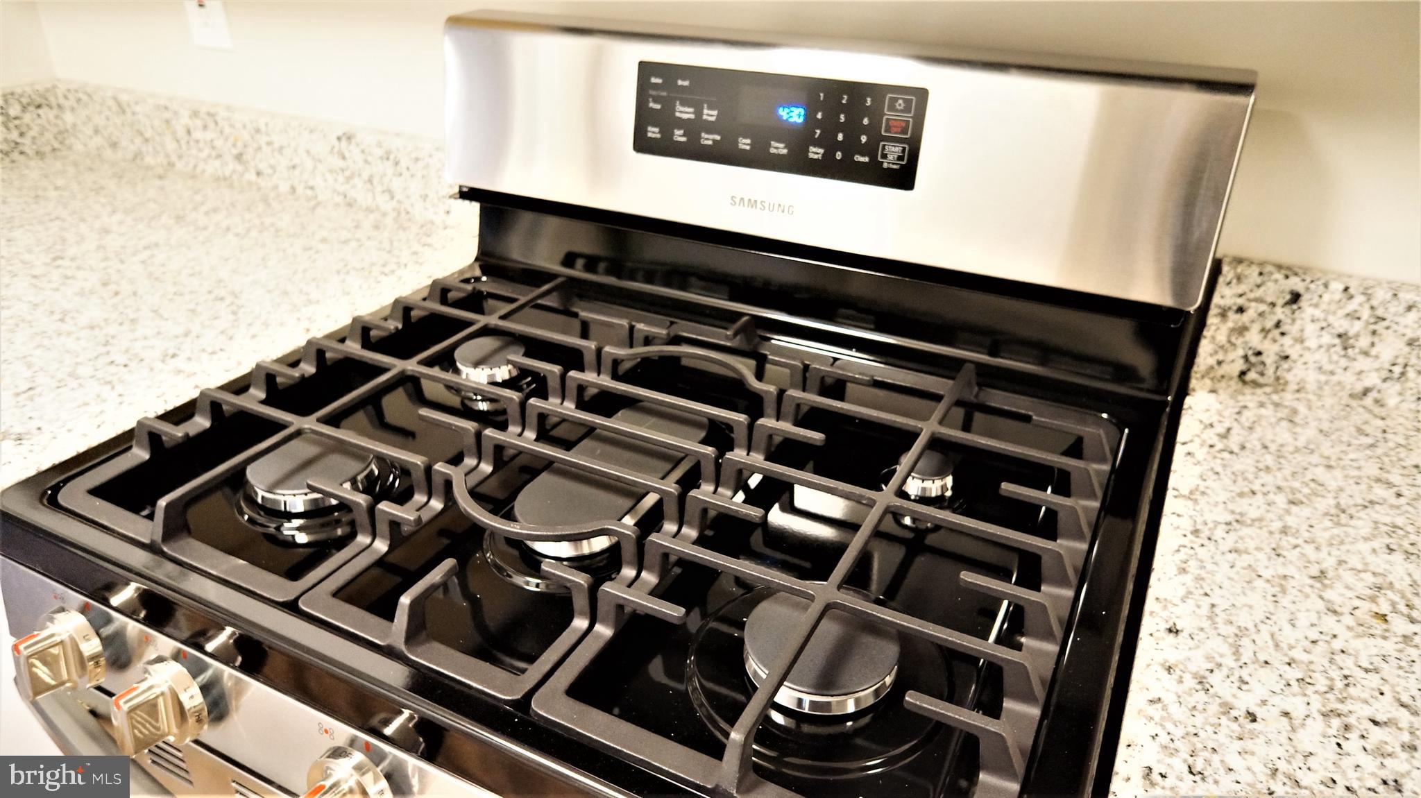 11818 Breton Court, Unit 1A Reston, VA 20191 - Photo 26 of 38 a close up of a stove top oven sitting on a counter
