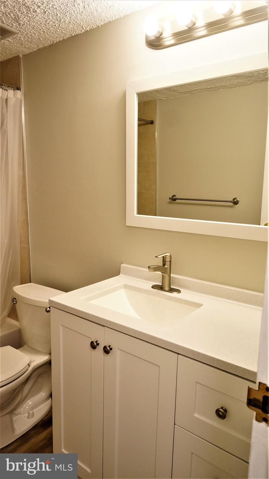 11818 Breton Court, Unit 1A Reston, VA 20191 - Photo 36 of 38 a bathroom with a sink and a toilet