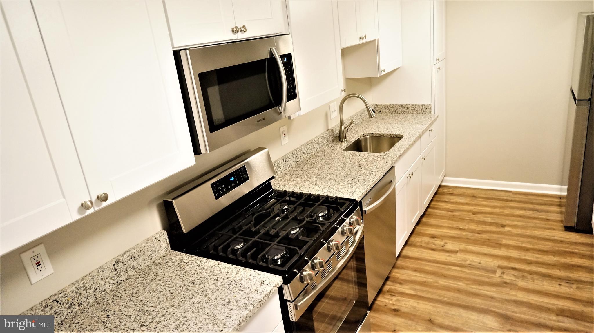 11818 Breton Court, Unit 1A Reston, VA 20191 - Photo 4 of 38 a kitchen with sink and washing machine