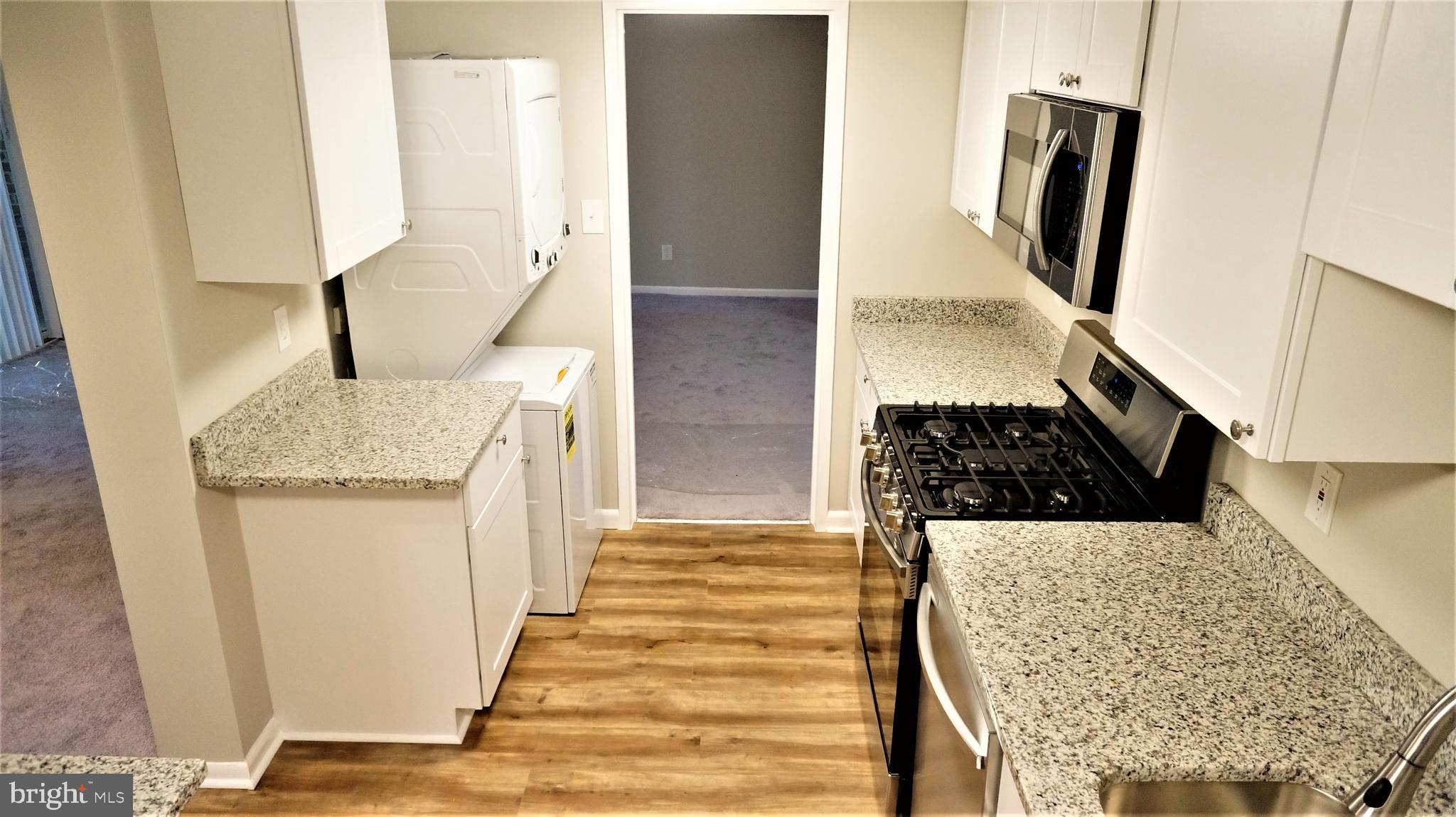 11818 Breton Court, Unit 1A Reston, VA 20191 - Photo 8 of 38 a bathroom with a granite countertop sink and a mirror