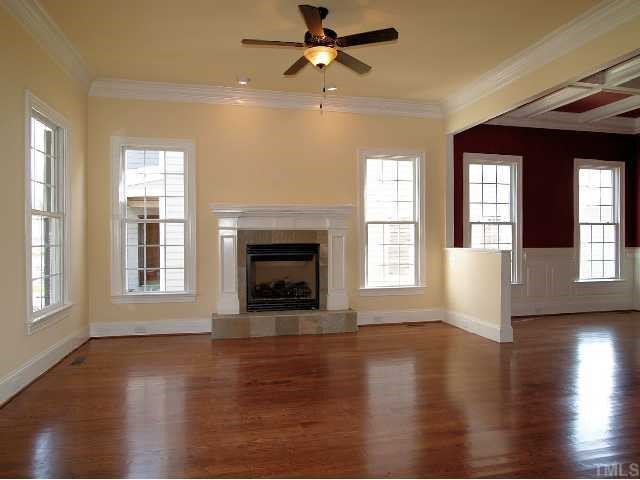 3109 Raymond Street Raleigh, NC 27607 - Photo 3 of 12 Large family room boasts gleaming hardwoods, gas log fireplace, ceiling fan, and lots of windows.