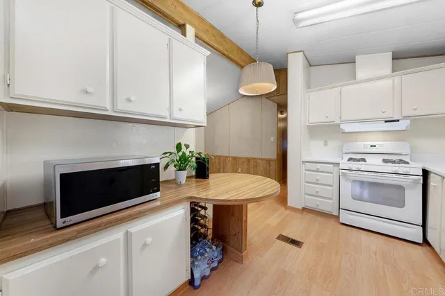 a kitchen with stainless steel appliances a stove microwave and cabinets