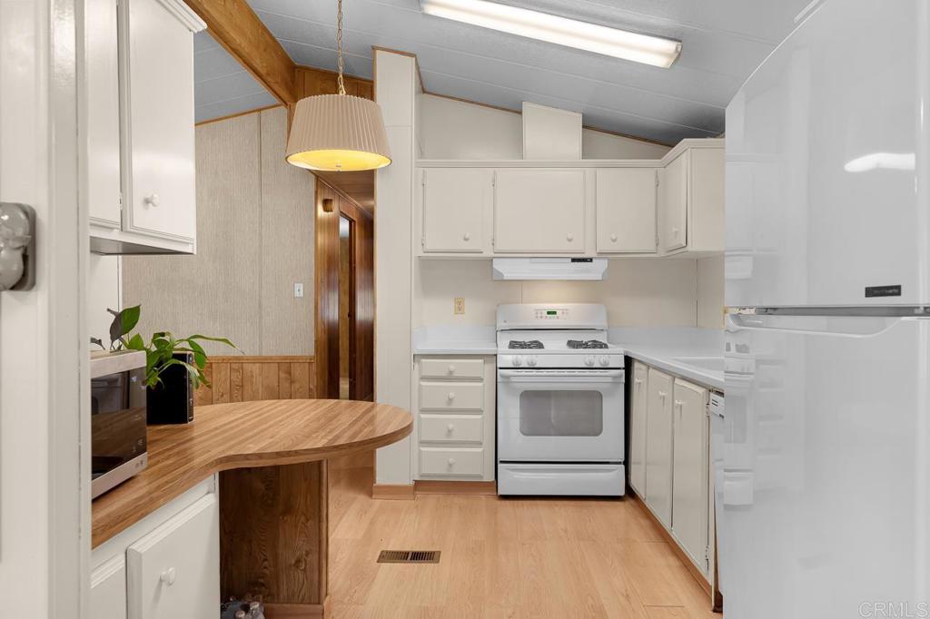 11949 Riverside Drive, Unit 133 Lakeside, CA 92040 - Photo 2 of 28 a kitchen with stainless steel appliances granite countertop a sink a stove and refrigerator