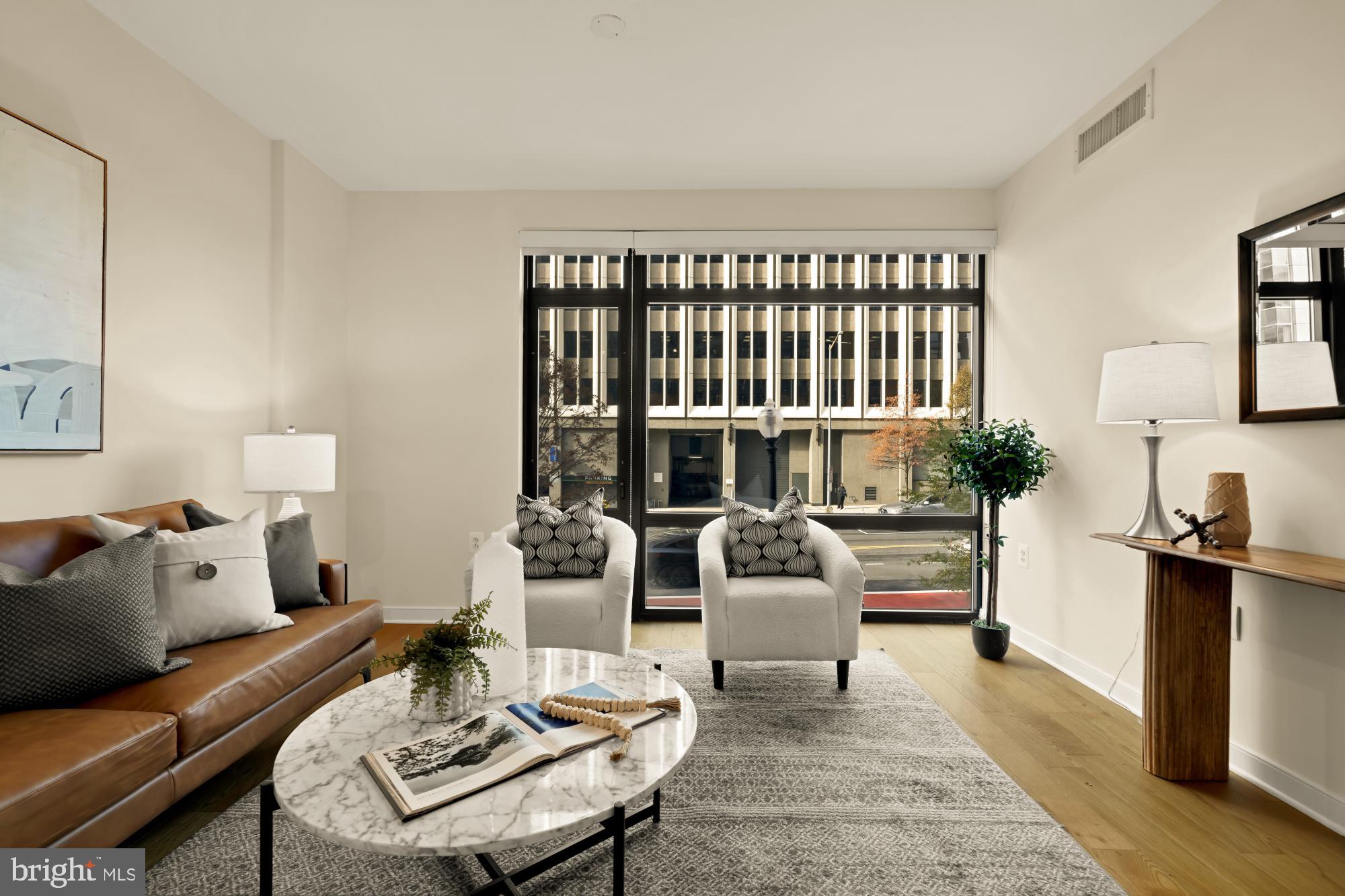 1010 Massachusetts Avenue Northwest, Unit 207 Washington, DC 20001 - Photo 12 of 31 a living room with furniture and a window