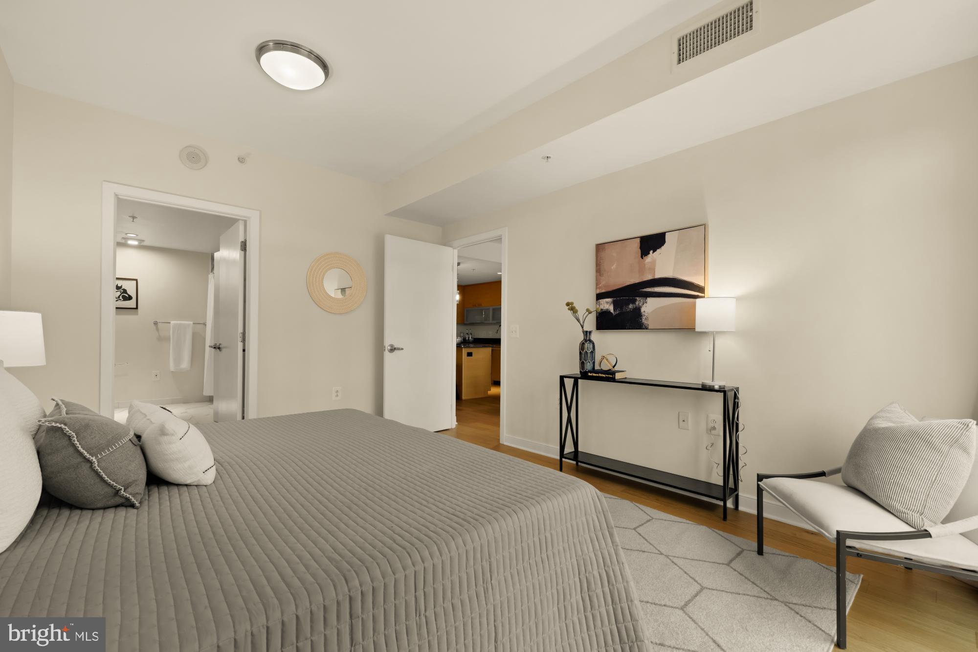 1010 Massachusetts Avenue Northwest, Unit 207 Washington, DC 20001 - Photo 14 of 31 a bedroom with a bed and a chair