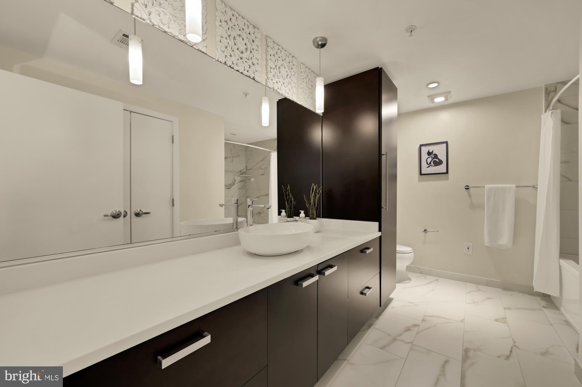 1010 Massachusetts Avenue Northwest, Unit 207 Washington, DC 20001 - Photo 16 of 31 a bathroom with a sink and a mirror