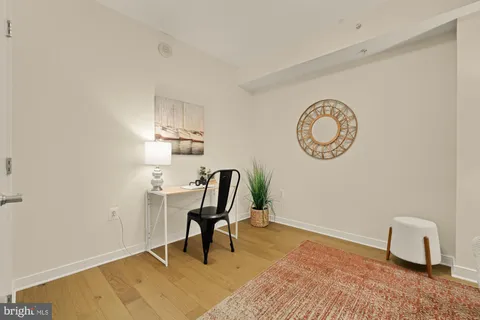 a view of a workspace with furniture and a window