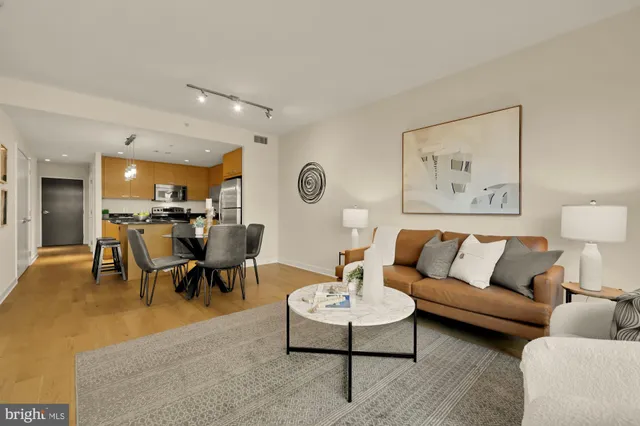 a living room with furniture kitchen view and a table