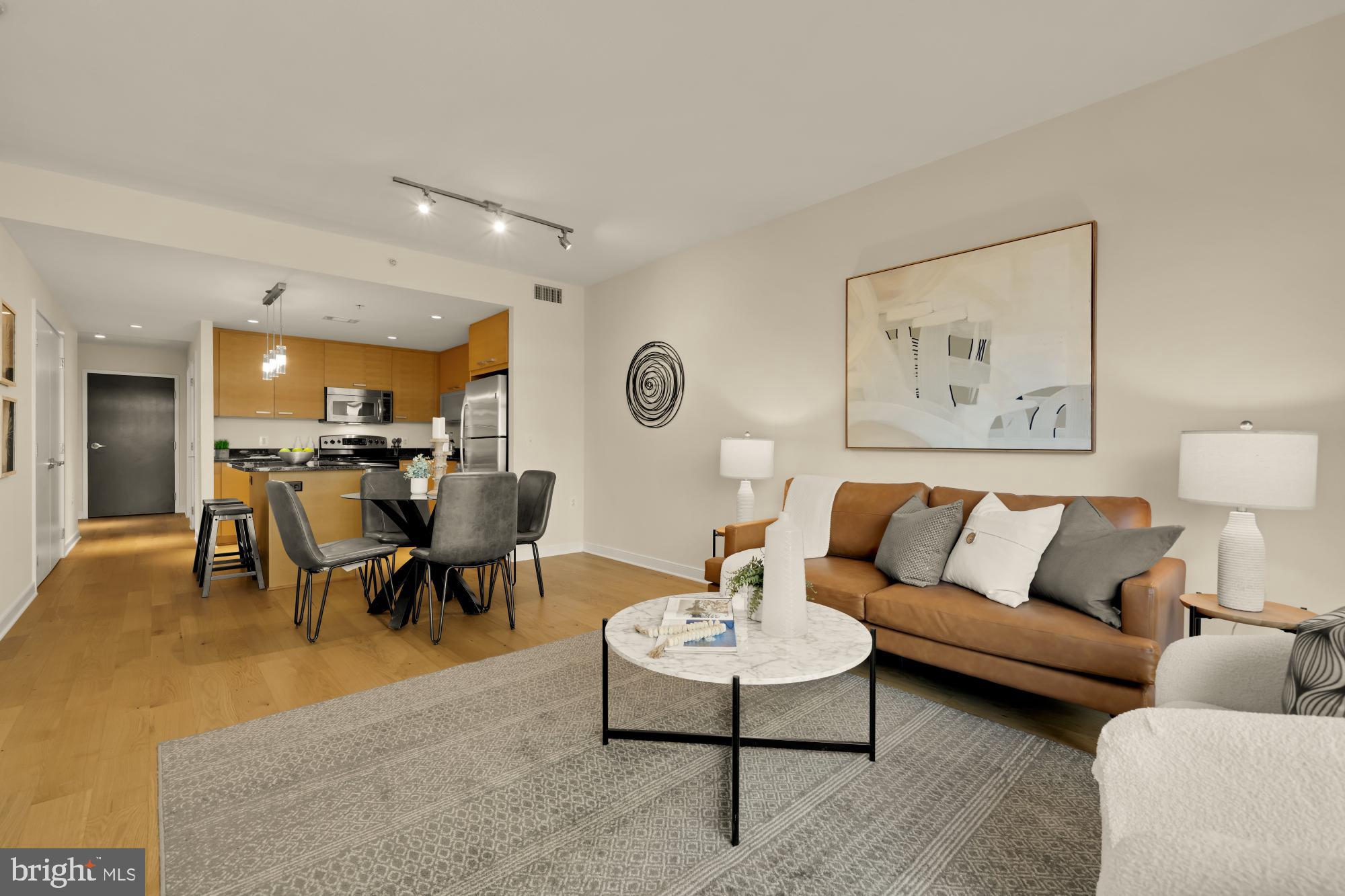 1010 Massachusetts Avenue Northwest, Unit 207 Washington, DC 20001 - Photo 2 of 31 a living room with furniture kitchen view and a table
