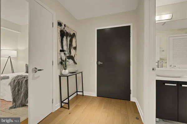 a view of a room with a sink and a mirror