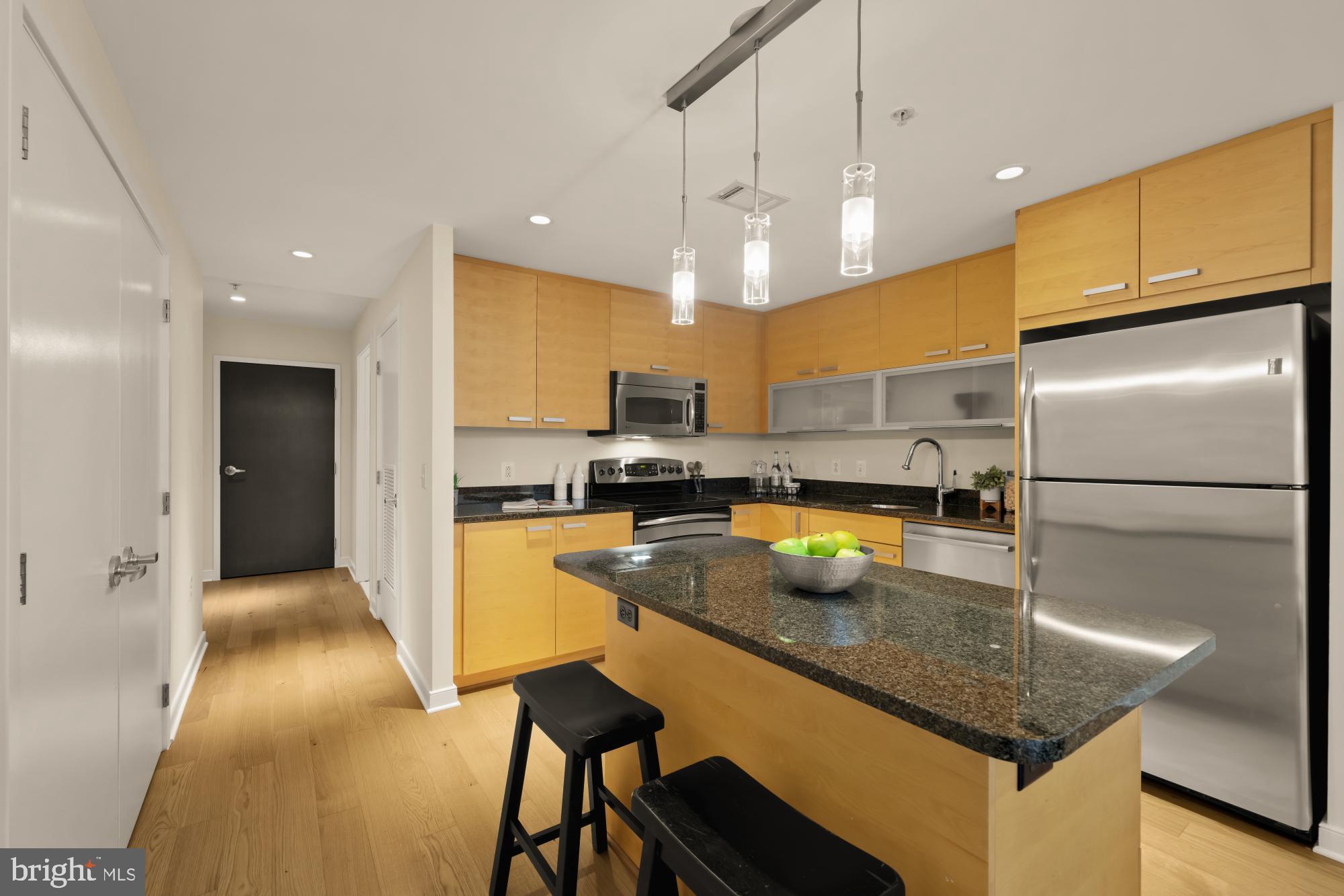 1010 Massachusetts Avenue Northwest, Unit 207 Washington, DC 20001 - Photo 5 of 31 a kitchen with refrigerator and couch