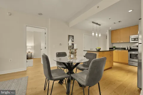 a view of a dining room with furniture and wooden floor