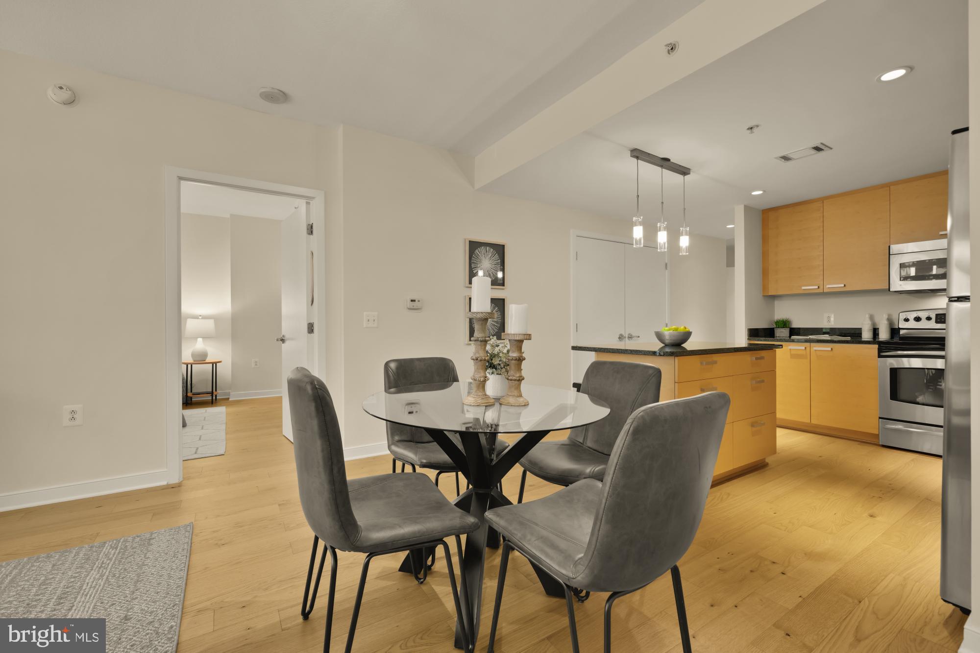 1010 Massachusetts Avenue Northwest, Unit 207 Washington, DC 20001 - Photo 9 of 31 a view of a dining room with furniture and wooden floor