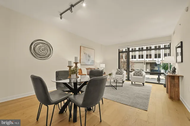 a living room with furniture a clock and a rug