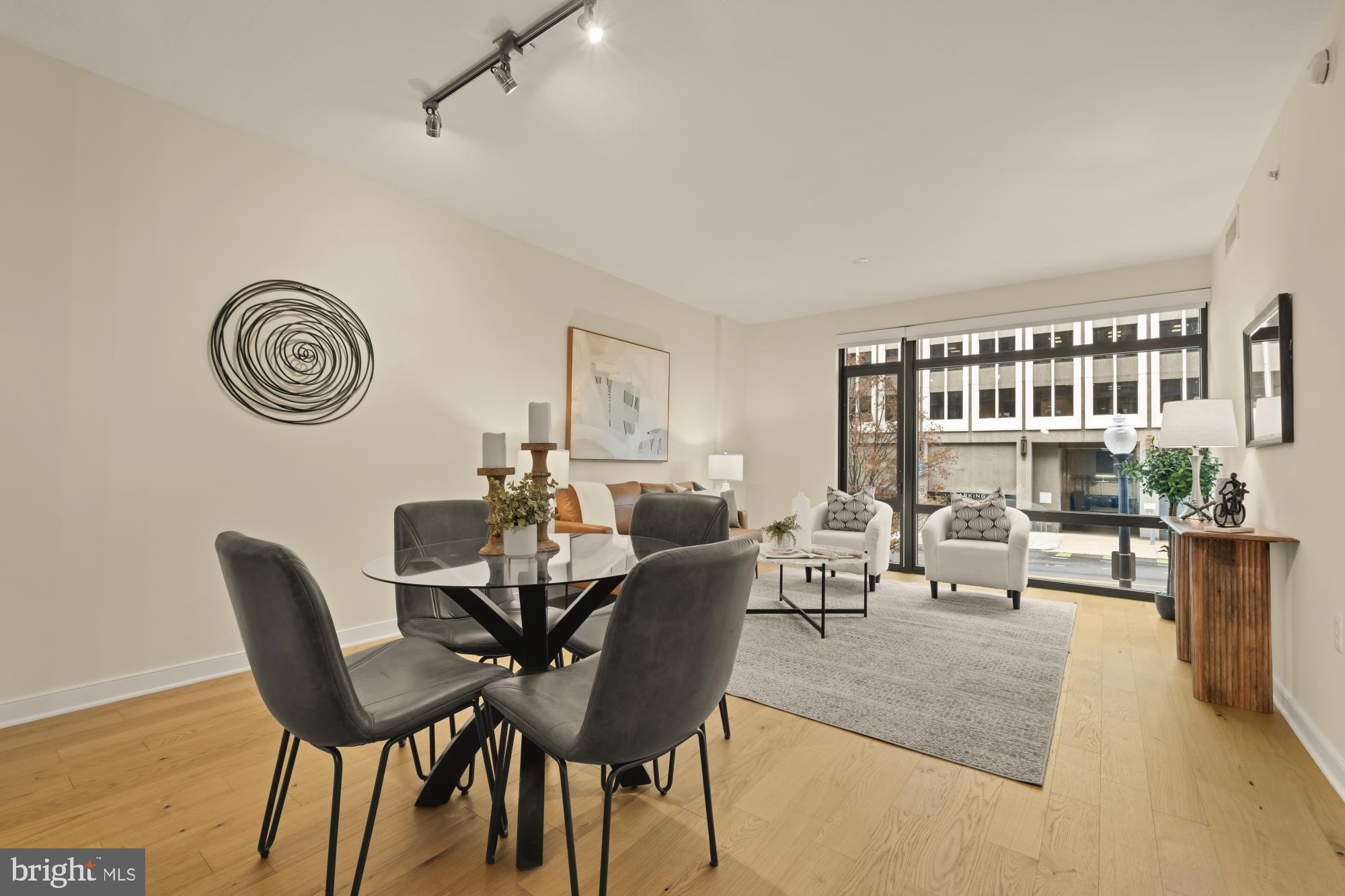 1010 Massachusetts Avenue Northwest, Unit 207 Washington, DC 20001 - Photo 10 of 31 a living room with furniture a clock and a rug