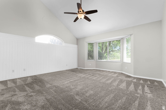 1417 Blacksmith Lane Draper, UT 84020 - Photo 20 of 57 Spacious room with a vaulted ceiling, a multi-panel bay window, a semi-circular transom window, and white wainscoting