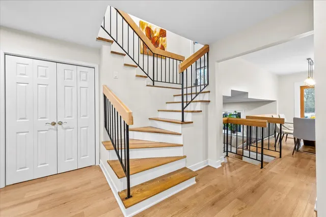 a view of entryway dining room and hall with wooden floor