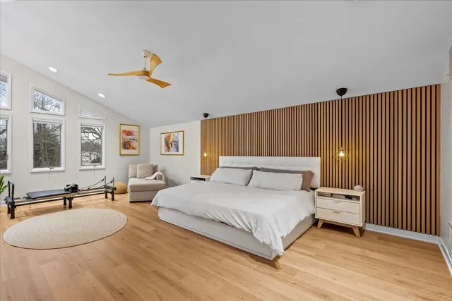 a bedroom with a bed couch and window