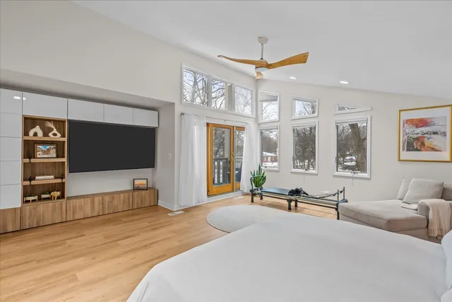 a spacious bedroom with a large bed and a large window