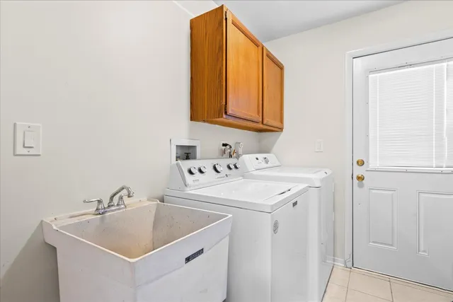 a utility room with a sink washer and dryer