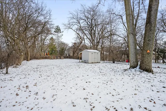 a house covered with snow in front of house