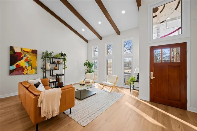 a living room with furniture wooden floor and wall painting