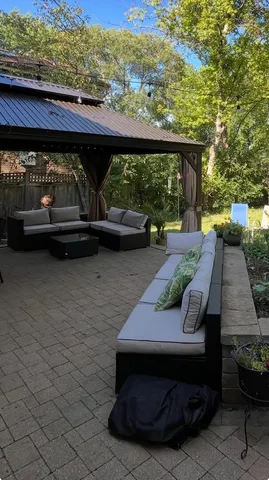 a view of patio with table and chairs and potted plants