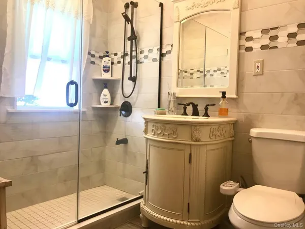 a bathroom with a toilet and a shower
