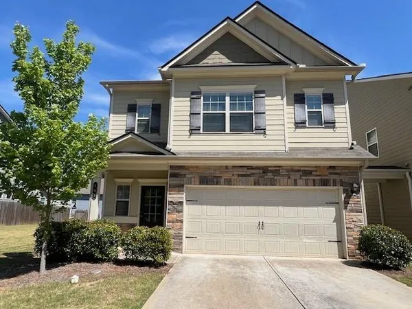 a front view of a house with a yard