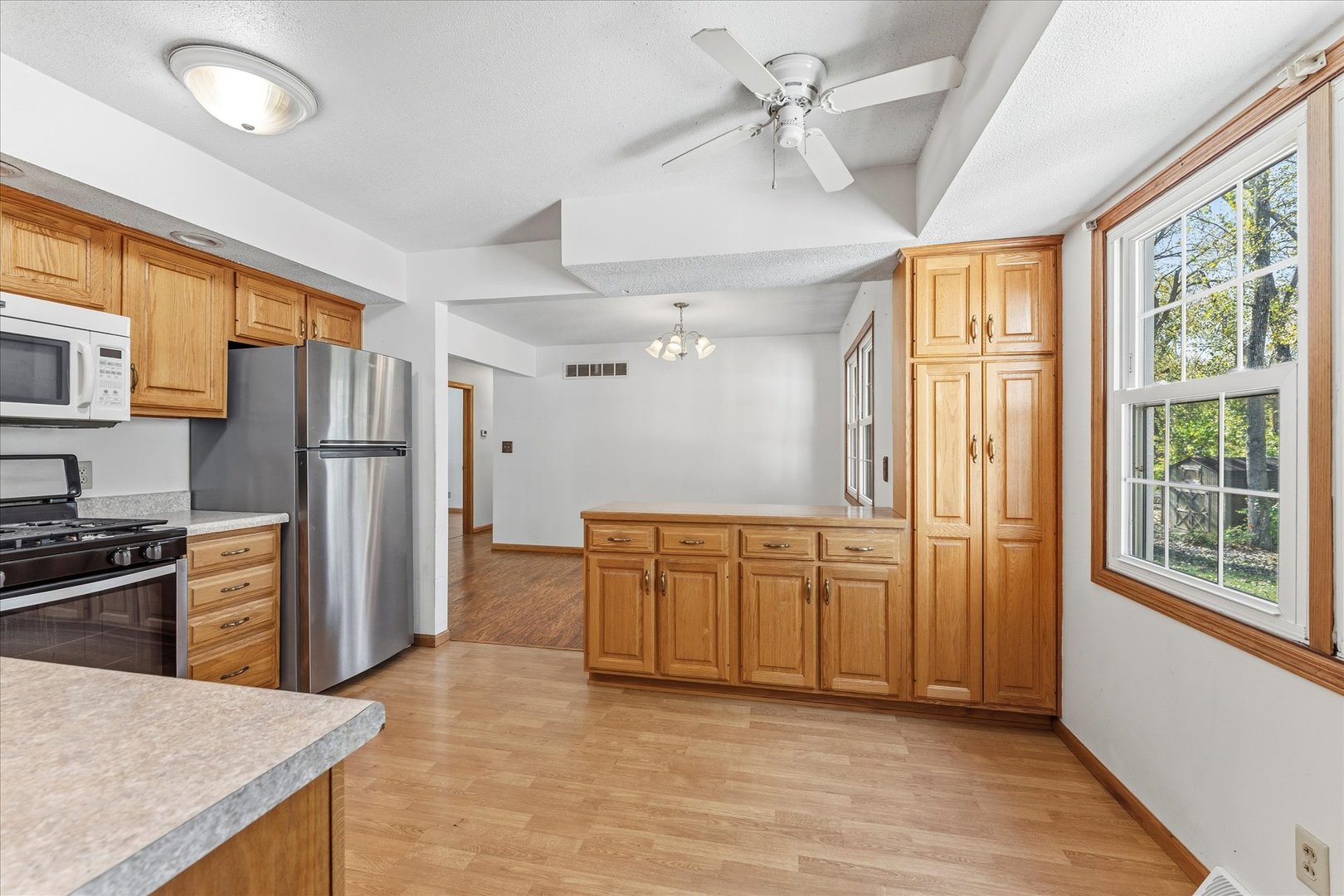 1101 McDougal Road Mahomet, IL 61853 - Photo 11 of 38 a kitchen with stainless steel appliances granite countertop a refrigerator a oven a sink with dishwasher and wooden cabinets
