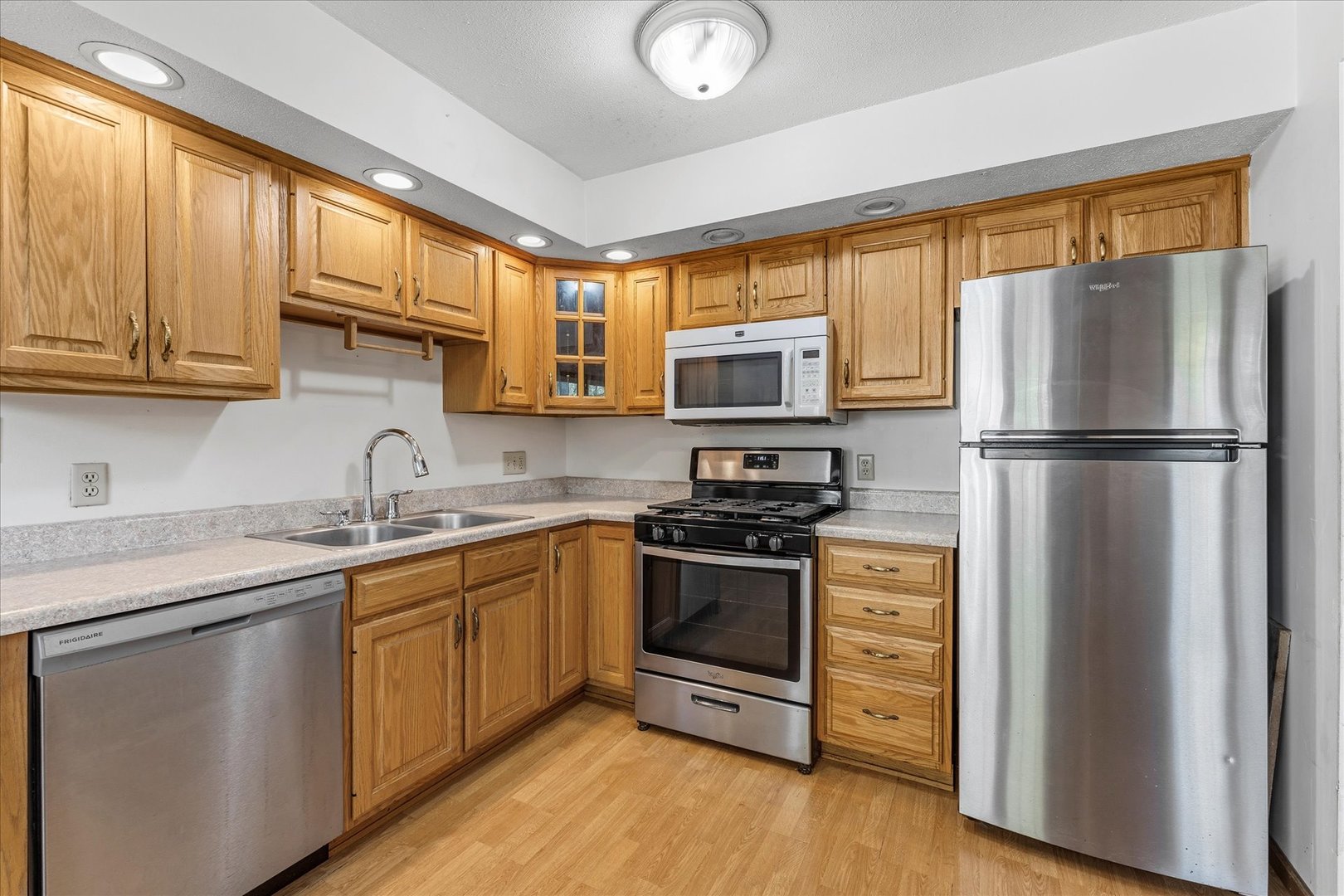 1101 McDougal Road Mahomet, IL 61853 - Photo 12 of 38 a kitchen with stainless steel appliances granite countertop a refrigerator stove a sink and a microwave