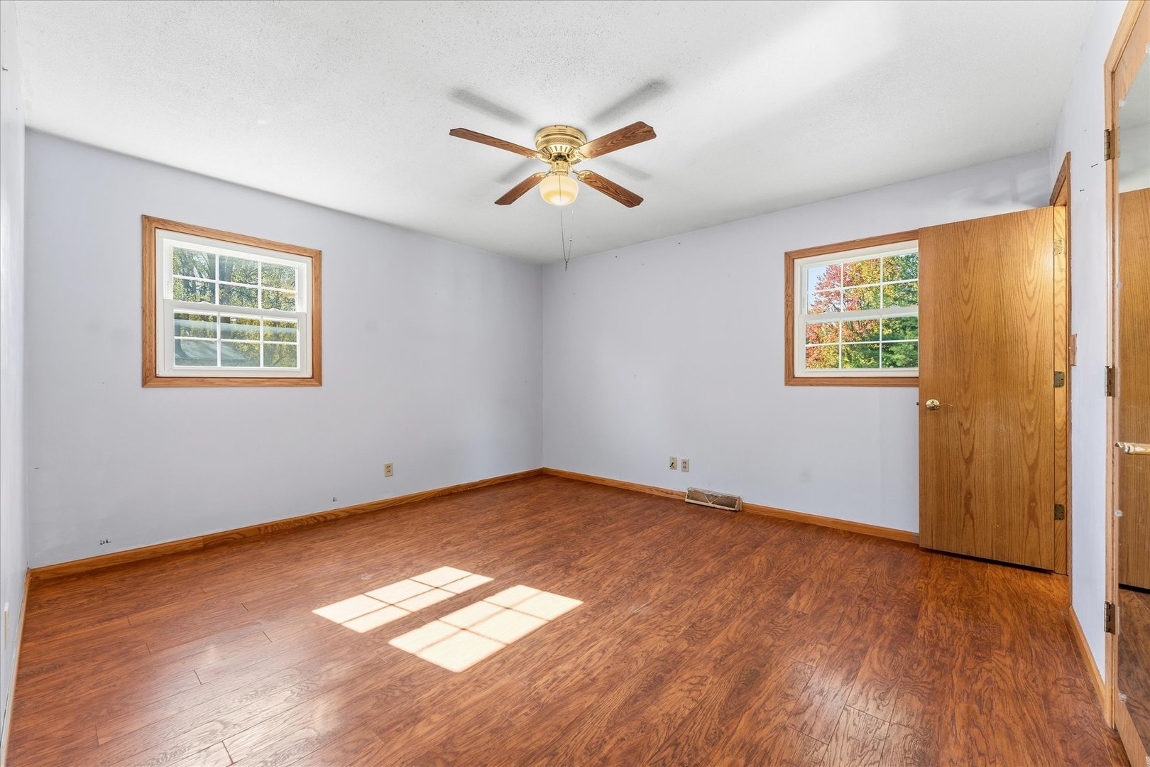 1101 McDougal Road Mahomet, IL 61853 - Photo 13 of 38 a view of a big room with windows and chandelier fan
