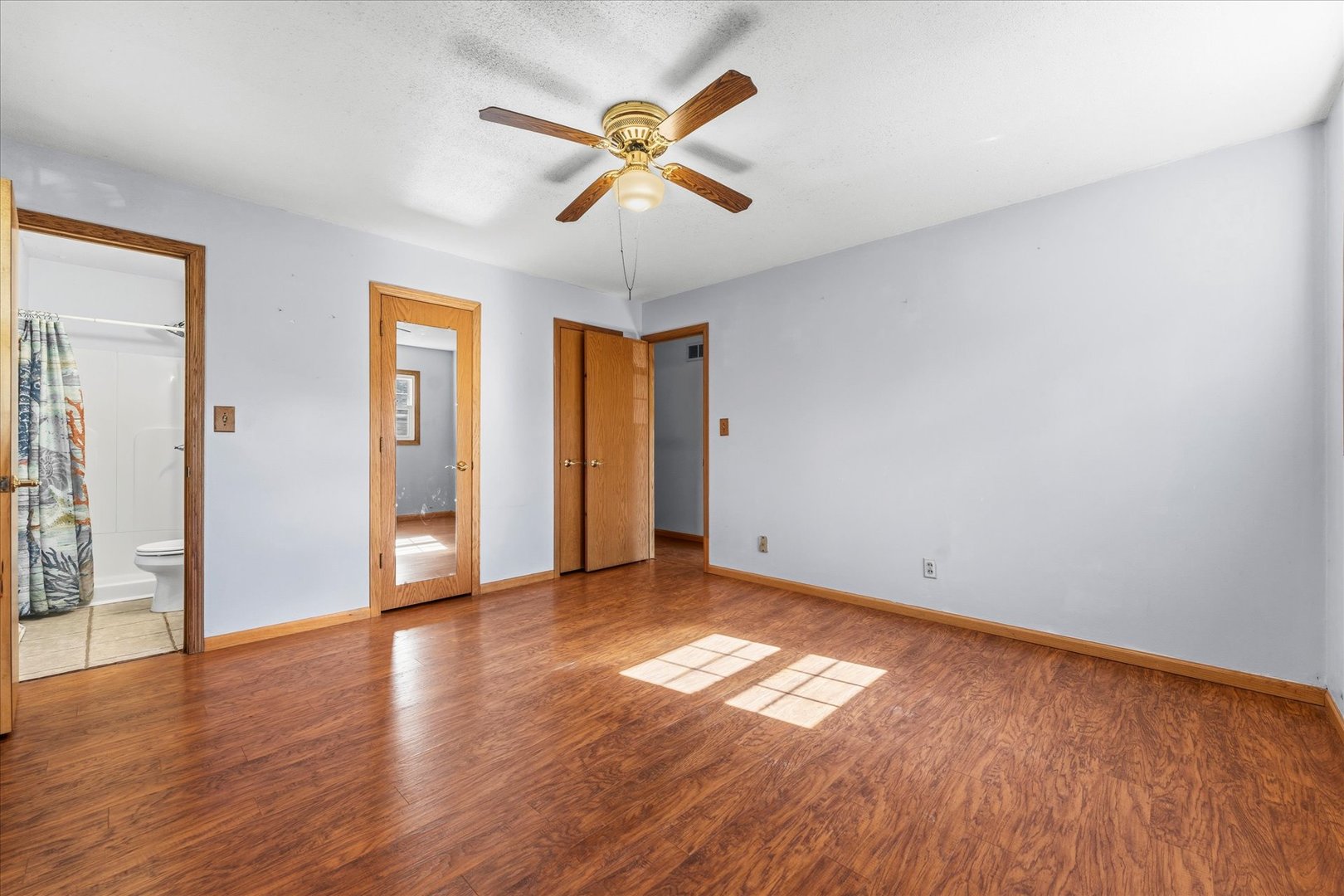 1101 McDougal Road Mahomet, IL 61853 - Photo 14 of 38 an empty room with wooden floor and windows