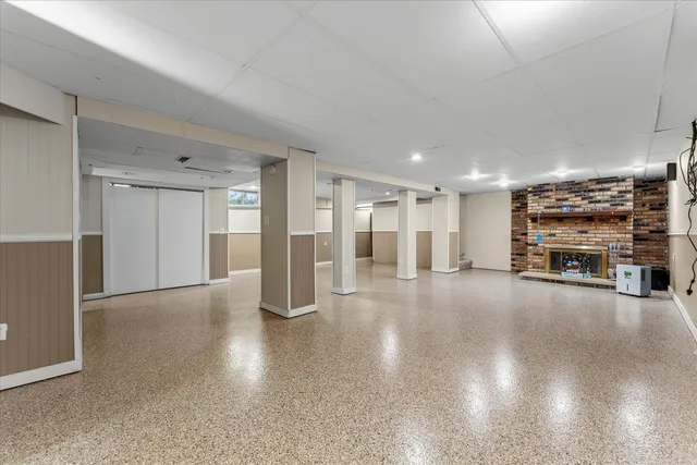 a view of a livingroom with furniture and a kitchen