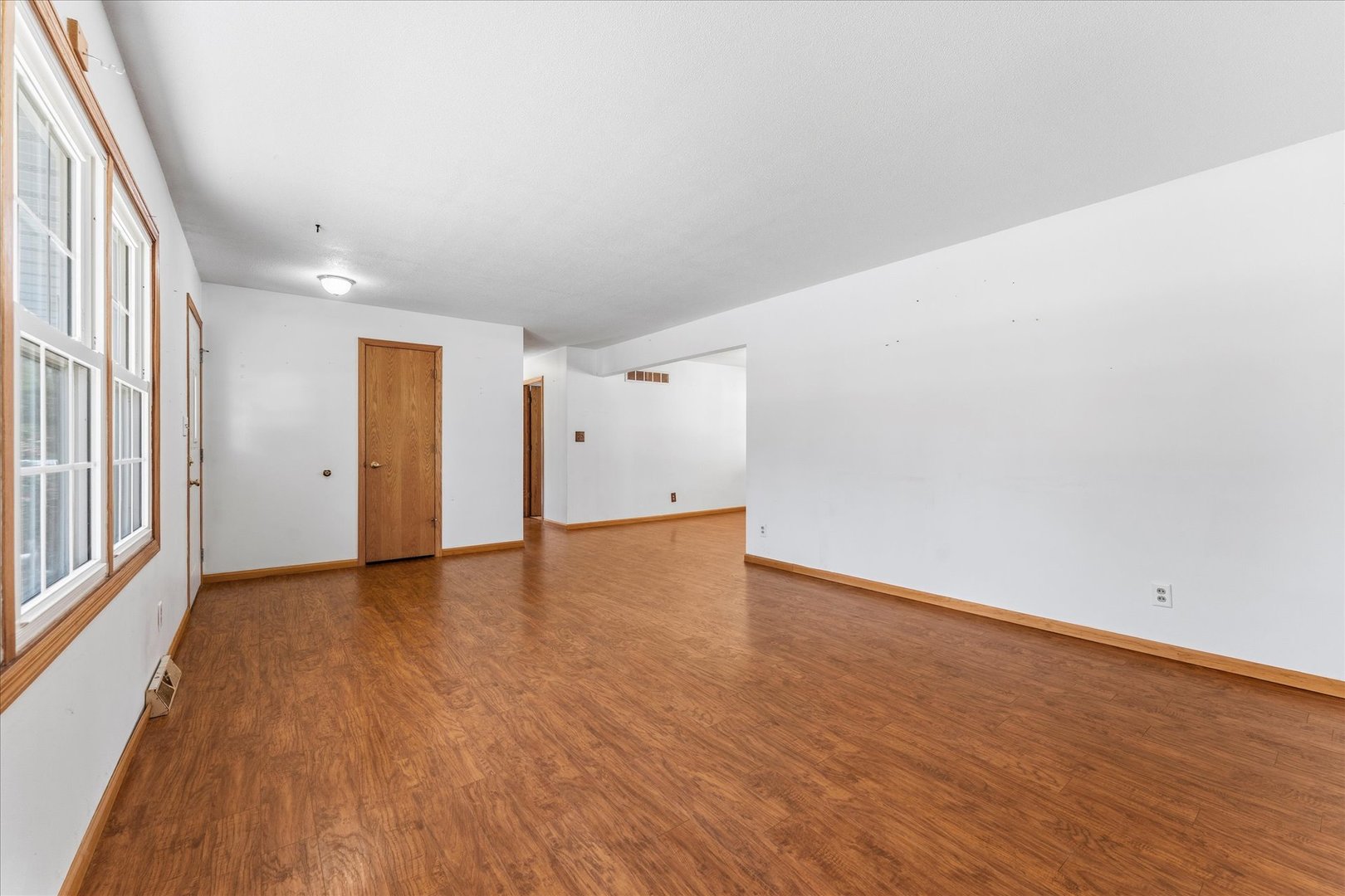 1101 McDougal Road Mahomet, IL 61853 - Photo 5 of 38 a view of an empty room with wooden floor and a window