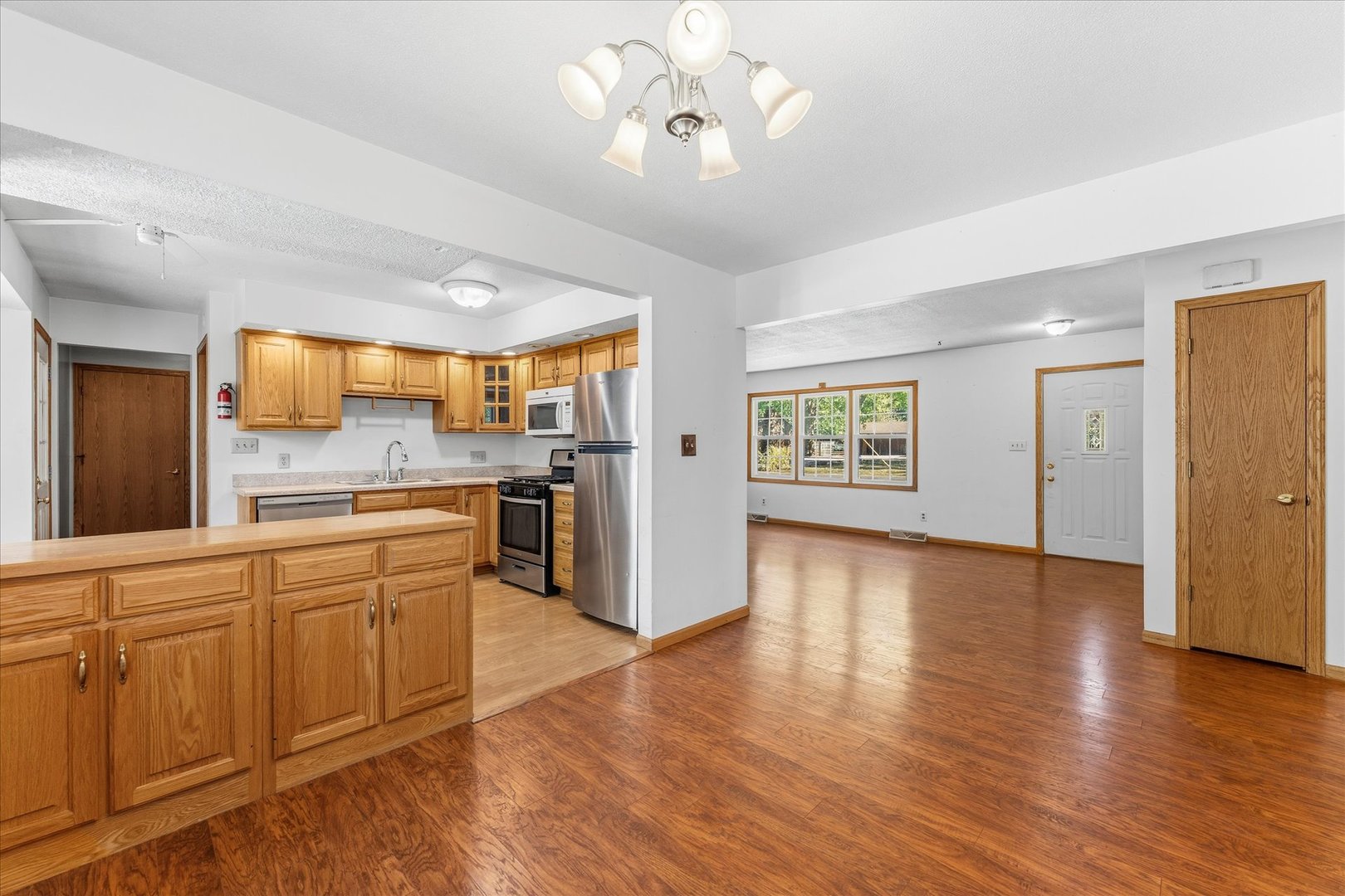 1101 McDougal Road Mahomet, IL 61853 - Photo 9 of 38 a large kitchen with lot of counter space stainless steel appliances and wooden floor