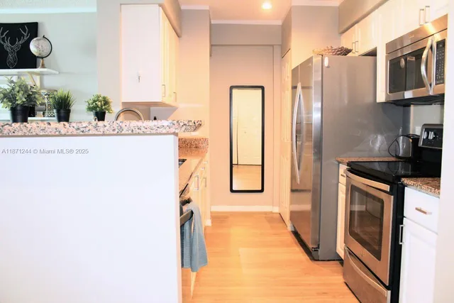 a kitchen with stainless steel appliances a refrigerator and a stove