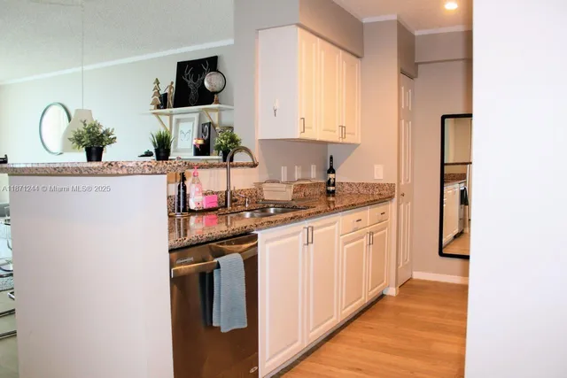 a kitchen with stainless steel appliances a sink and a refrigerator