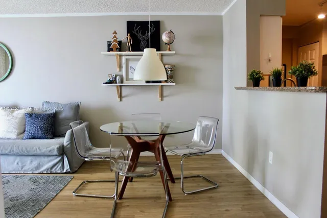 a view of a room with furniture and wooden floor