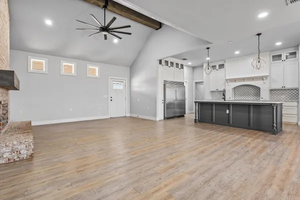 a view of a kitchen with a sink and a refrigerator