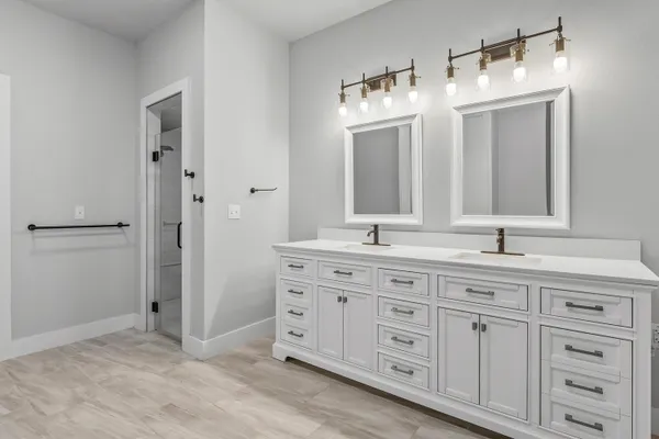 a bathroom with a granite countertop sink double and mirror