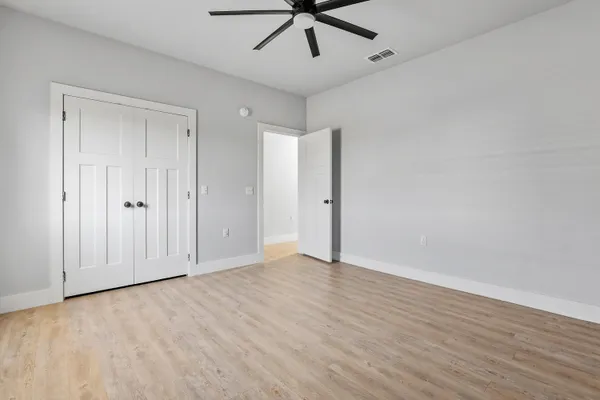 a view of an empty room with a ceiling fan