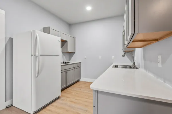 a kitchen with a refrigerator and a stove