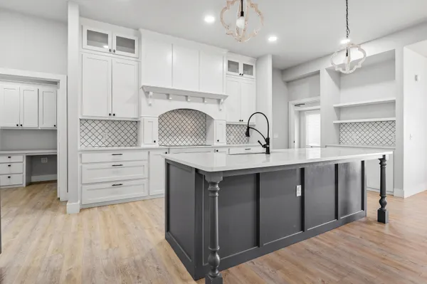 a kitchen with kitchen island a sink stainless steel appliances and cabinets