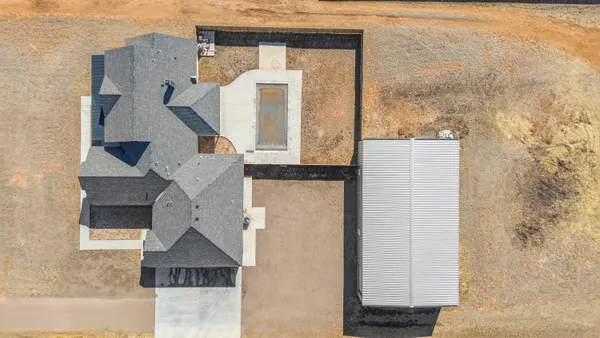 an aerial view of residential houses with outdoor space