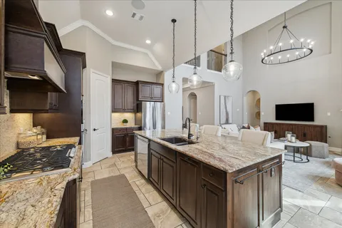 a kitchen with granite countertop stainless steel appliances and wooden cabinets