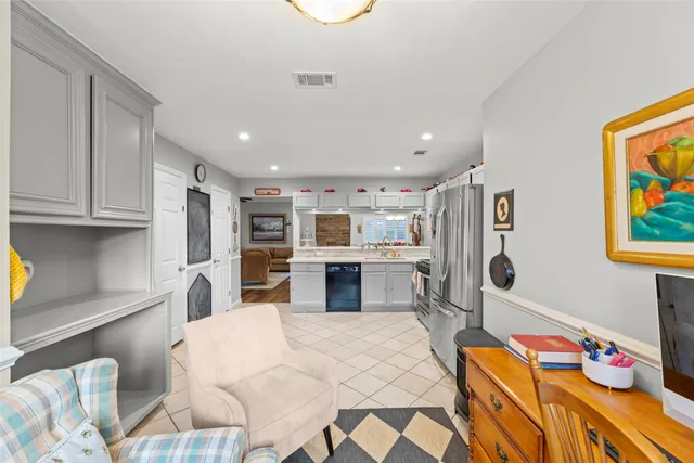 a bedroom with furniture and a flat screen tv